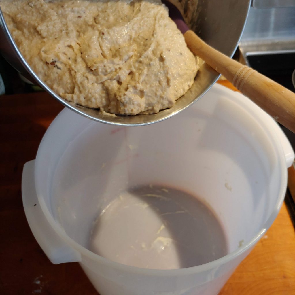 Putting bread dough in covered food storage container