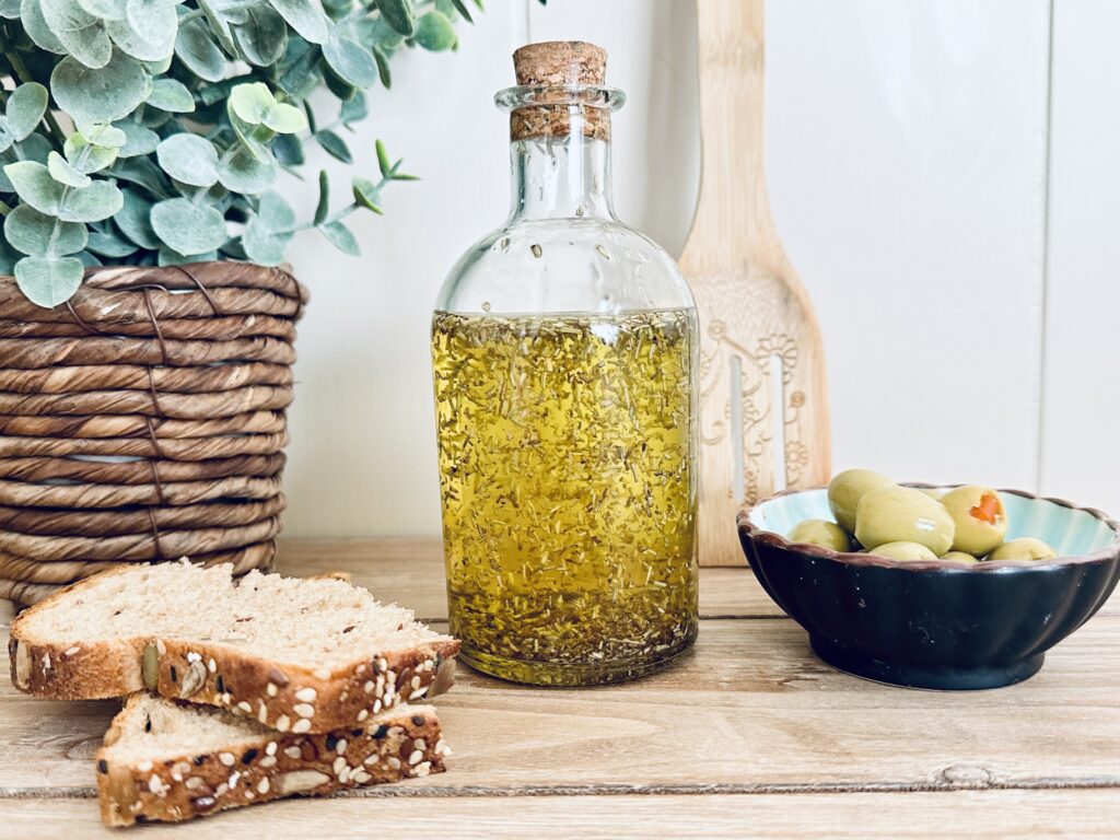 rosemary oil with olives and bread and cutting board