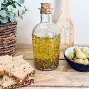 How to Make Rosemary Oil 5 rosemary oil with olives and bread and cutting board