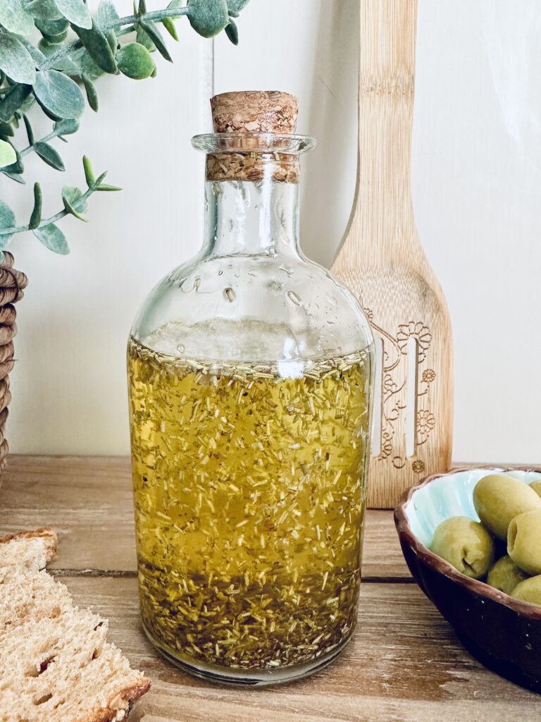 rosemary oil with olives and bread and cutting board