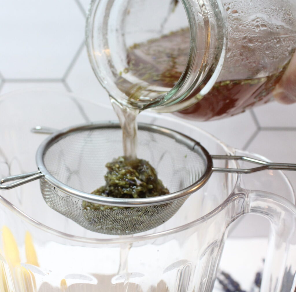 straining lavender soaking in jar with lemon