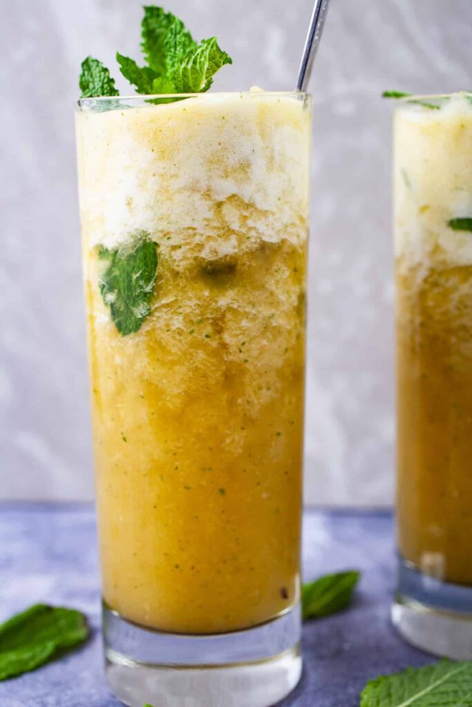 Sparkling pineapple mocktail drink with mint in a tall glass