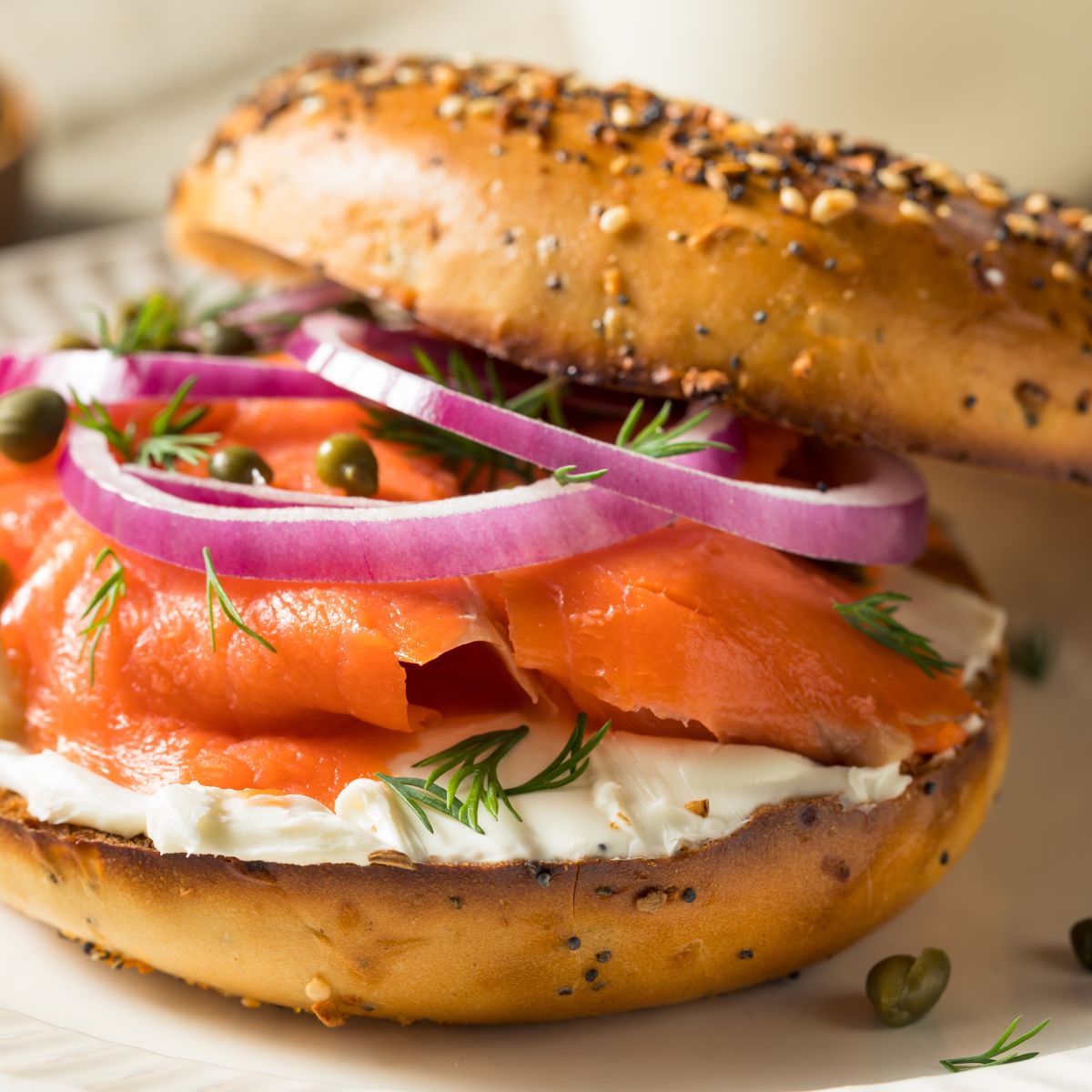 a bagel with cream cheese, onions, and smoked salmon