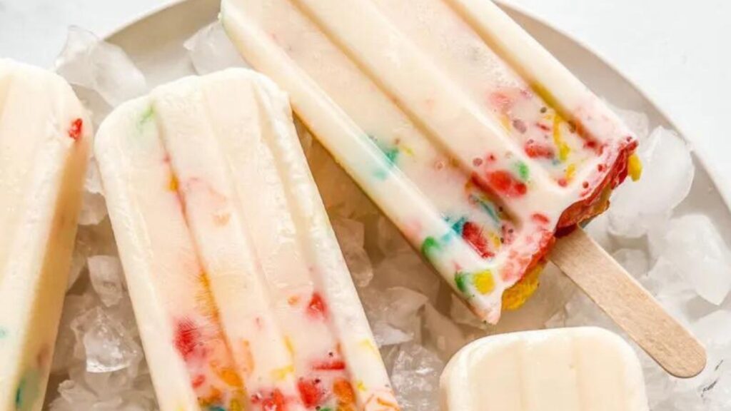 21 Delightful Homemade Popsicle Recipes 3 Several breakfast cereal popsicles on a plate with ice.