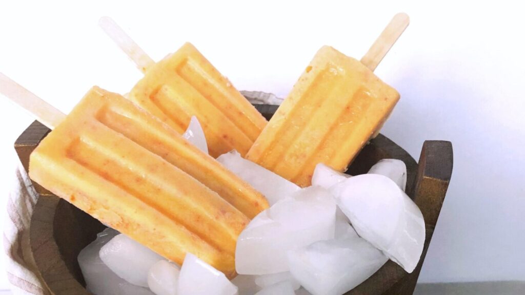 21 Delightful Homemade Popsicle Recipes 17 fresh peaches and cream popsicle in wooden barrel