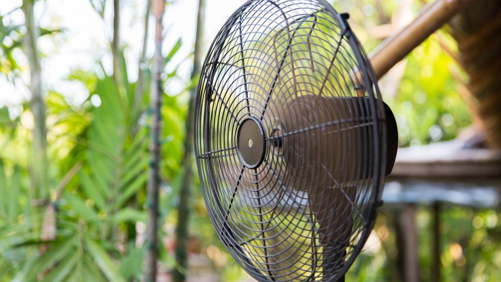 15 Essential Items to Stockpile in March for Long Term Preparedness 15 cooling, freshness and heat concept - close up of fan outdoors