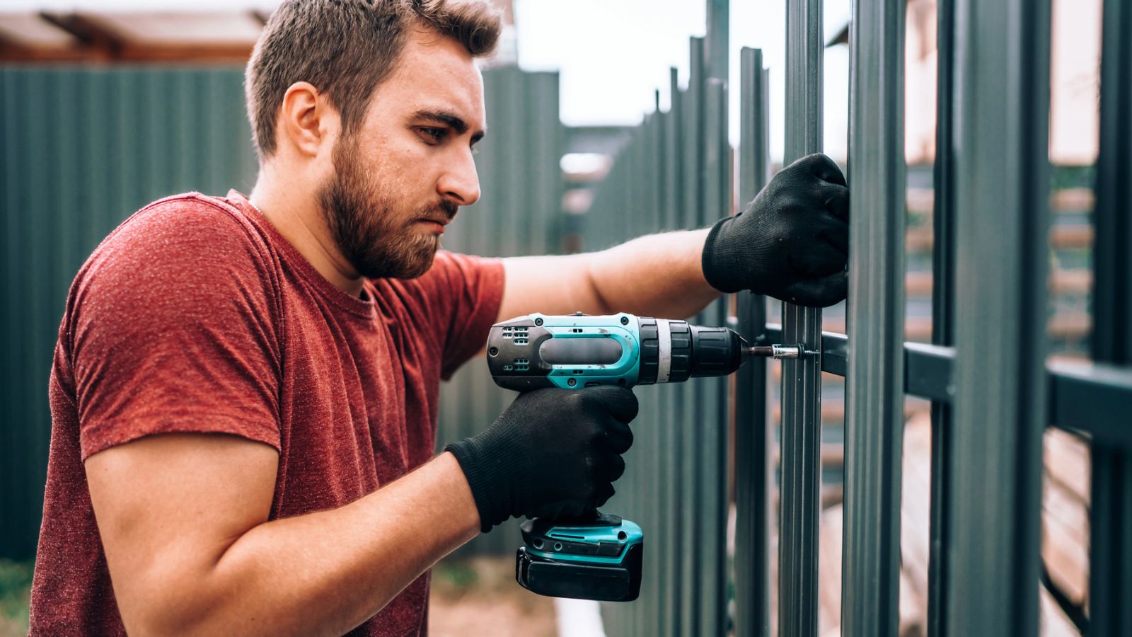 guy drilling fence