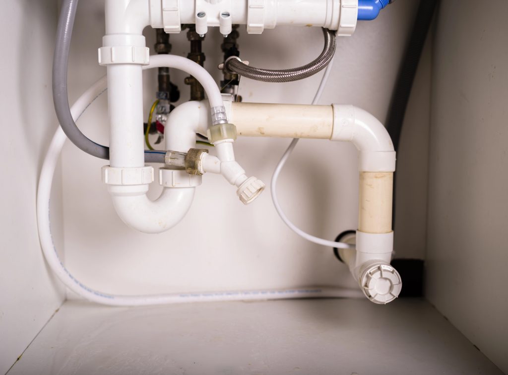 17 Practical DIY Skills You'll Wish You Had Learned Before an Emergency 1 Pipes and plumbing under sink