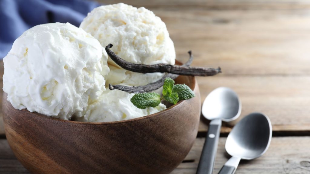 15 Grocery Items Hiding More Chemicals Than Nutrients (and What to Buy Instead) 15 Yummy vanilla ice cream in bowl on wooden table, closeup.