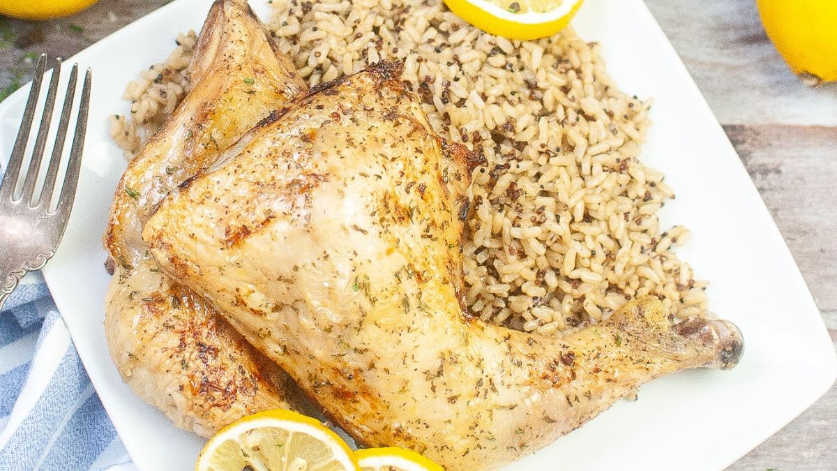 30 Cheap Dinner Ideas To Help Stretch Your Grocery Budget 10 A plate with chicken, rice and lemons on it.