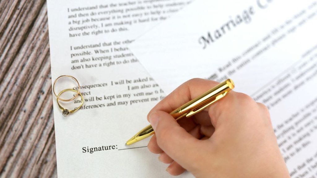 19 Important Documents You Should Never Throw Out 6 Marriage contract with two golden wedding rings and gold pen, prenuptial agreement, macro close up, sign with signanture, document,agreement concept romance