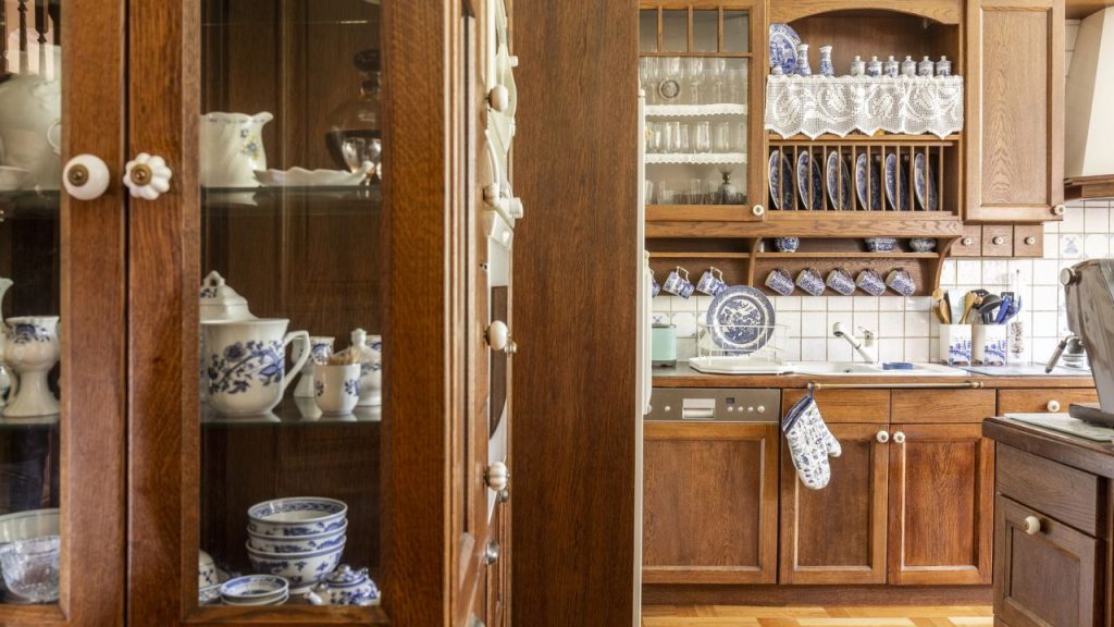 12 Clever Spots Where Preppers Can Store Their Emergency Food 7 Old fashioned wooden cabinets with white and cobalt blue china in kitchen interior.