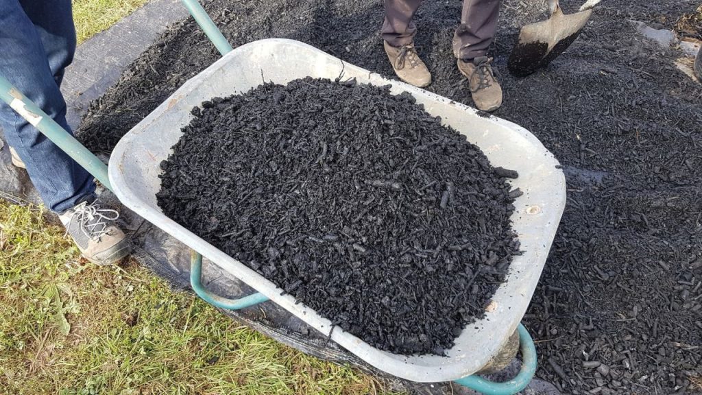 How To Fill a Raised Garden Bed for a Successful Harvest 9 Use of biochar in the vegetable garden. biochar for plants. biochar in a wheelbarrow. use biochar in fruit trees and plants in the backyard garden
