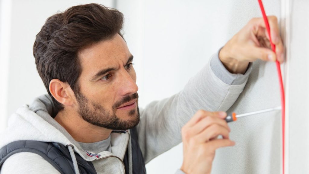 How to Prepare for the Long Term If the Power Grid Were to Fail 8 Young and handsome installing weatherstripes