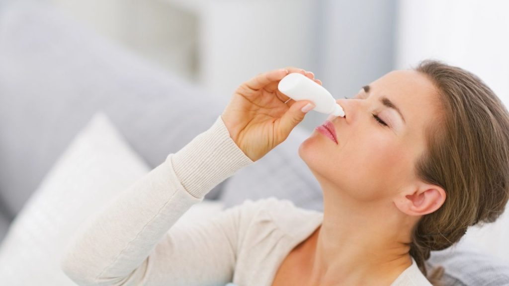 15 Over-the-Counter Medications You Should Stockpile 3 Young woman using nose drops