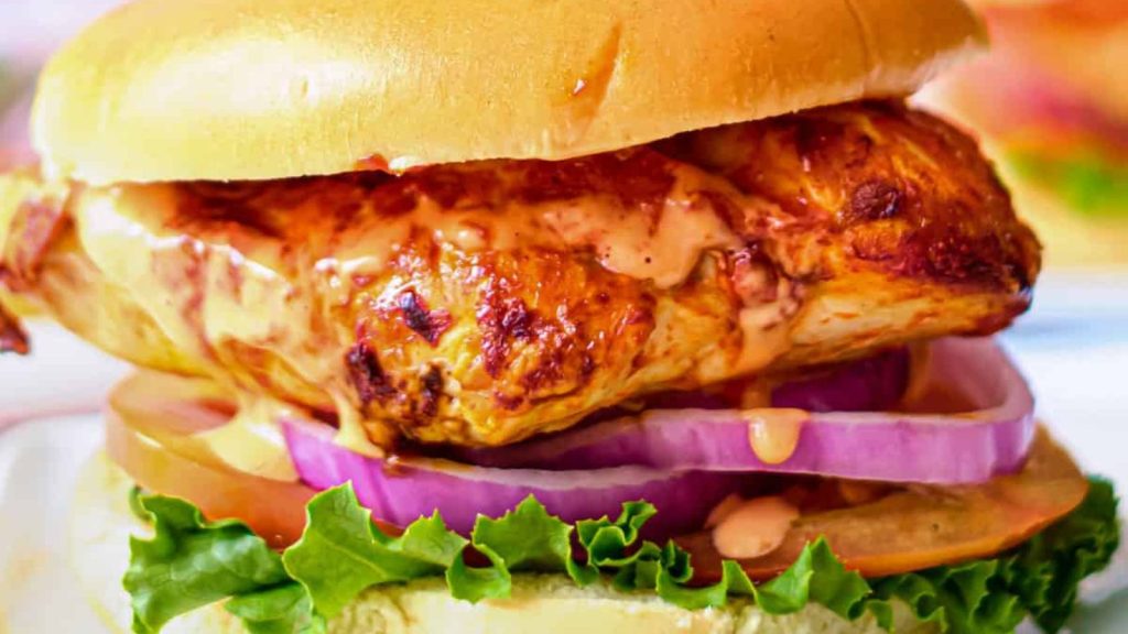 25 Gourmet Sandwiches Perfect for Your Next Lunch Break 16 the assembled buffalo chicken sandwich served on a white plate