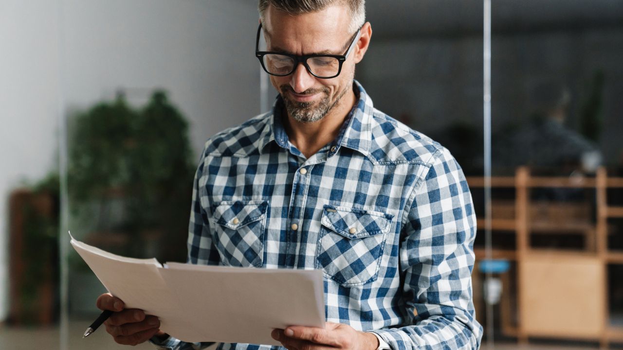 man with documents in hand
