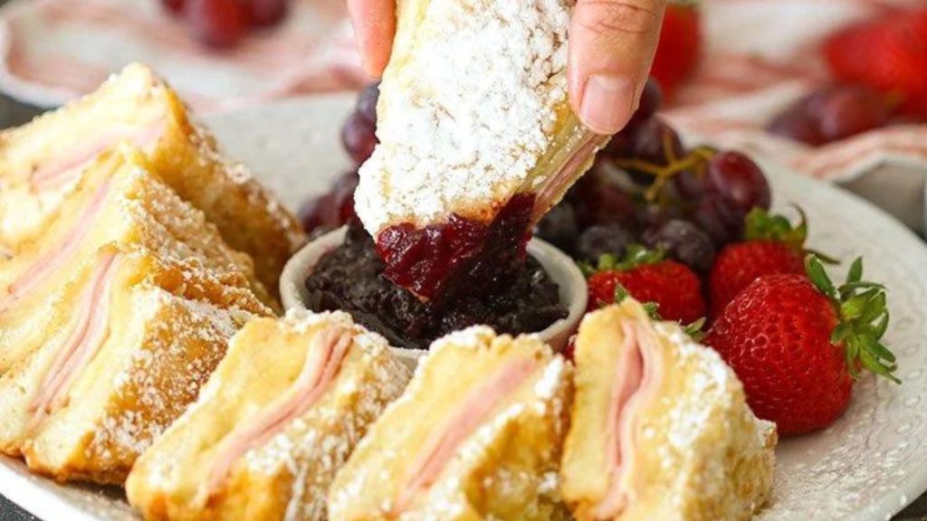 25 Gourmet Sandwiches Perfect for Your Next Lunch Break 6 dipping monte cristo sandwich in blackberry jam