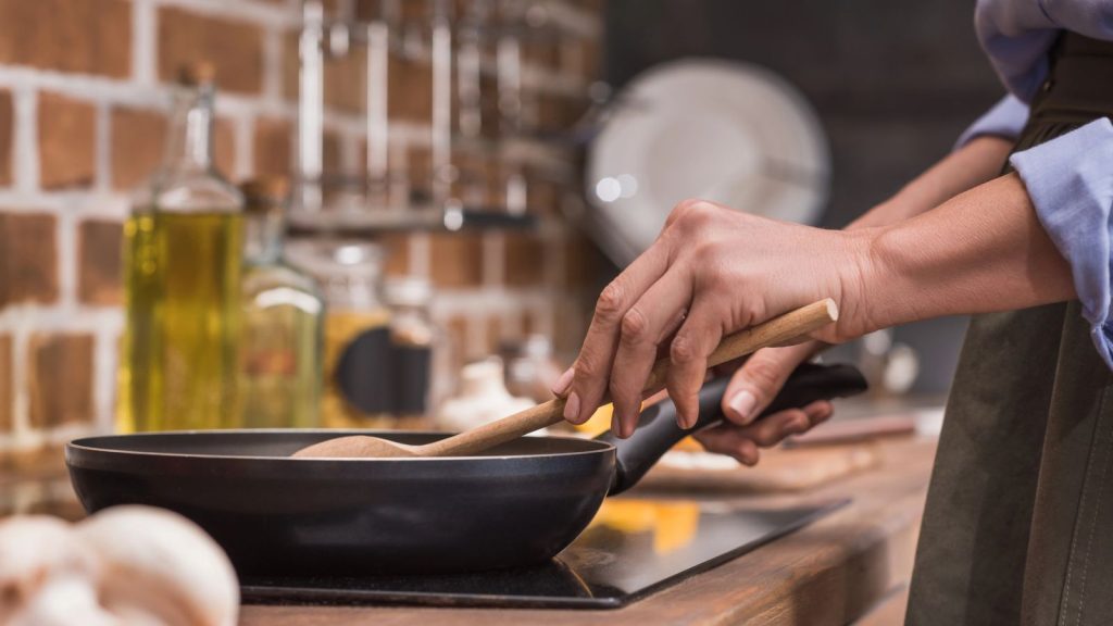 woman cooking on a non stick pan kitchen