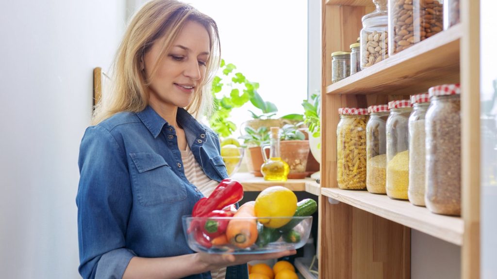 14 Things You Should Never Store in the Basement 3 woman with fruits and vegetables in pantry