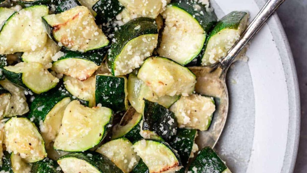 23 Easy, Tasty, and Totally Addictive Air Fryer Vegetables 18 Air fryer zucchini in a serving bowl with a spoon.