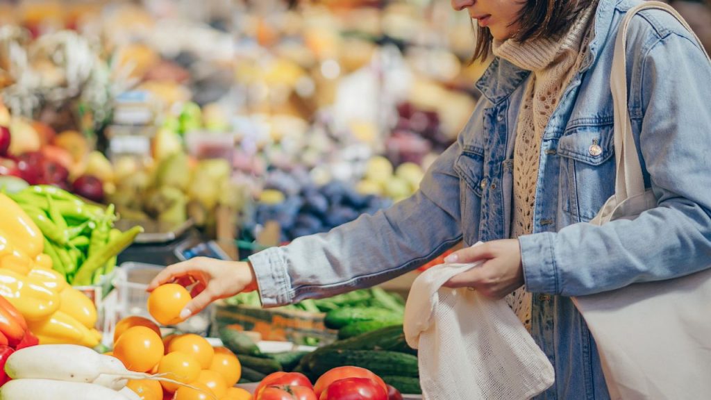 Looking for Cheap Groceries? 13 Best Grocery Stores for Budget Shoppers 16 woman shopping grocery section in supermarket