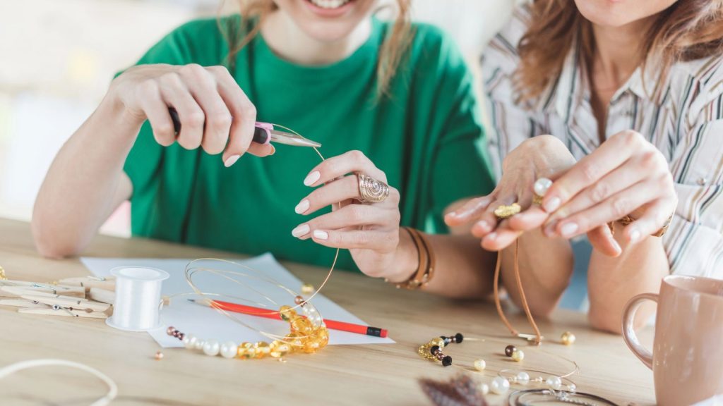 women making personalized accessories with linesman pliers in workshop
