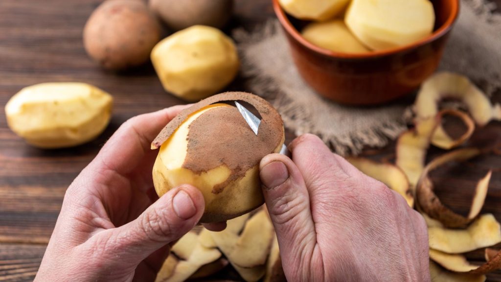 Are Sprouted Potatoes Safe to Eat? Here’s What You Should Know 8 man peeling potatoes