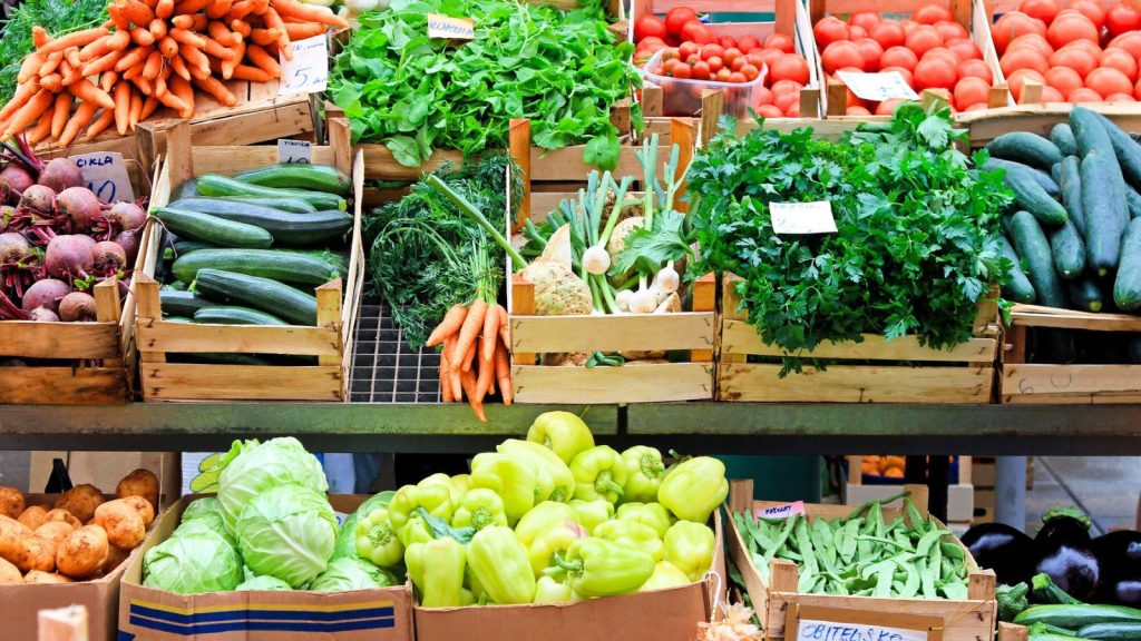 17 Ways to Put Old Newspapers to Work in Your Garden 11 market with fruits and vegetables on stand