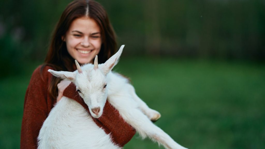 The Real Reason So Many People Keep Goats on Their Land 9 woman with goat