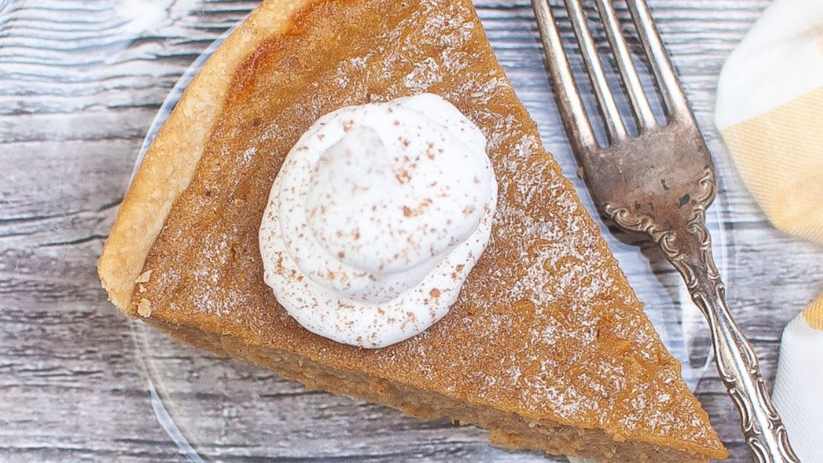 21 Homemade Pies So Good Everyone Will Practically Beg for Seconds 6 A slice of pumpkin pie with whipped cream on a plate.