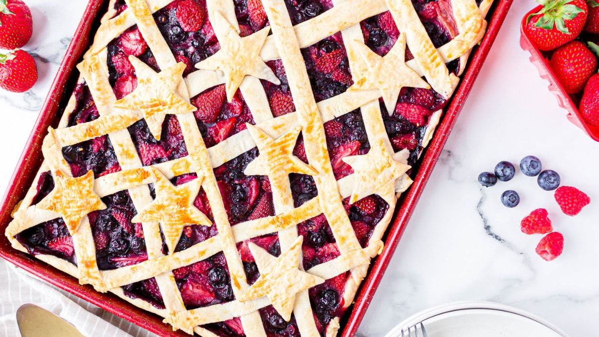 21 Homemade Pies So Good Everyone Will Practically Beg for Seconds 4 A pie with berries and a fork on a white plate.