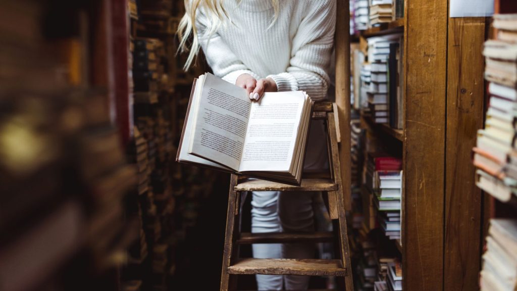 14 Things You Should Never Store in the Basement 4 woman in library with book