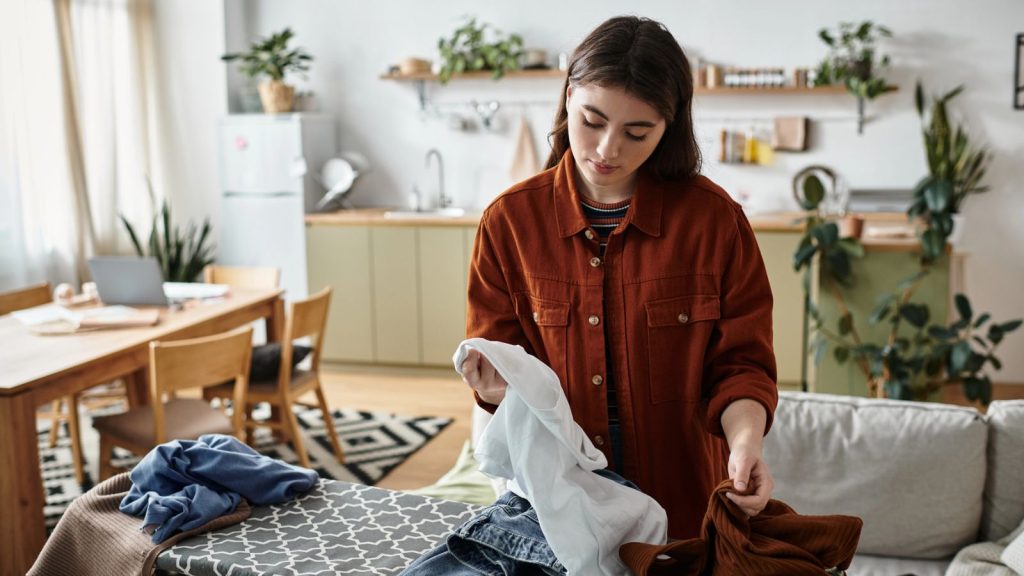 I Use Dryer Sheets All Over My House—And Hardly Ever in the Dryer 6 woman sorting through clothes