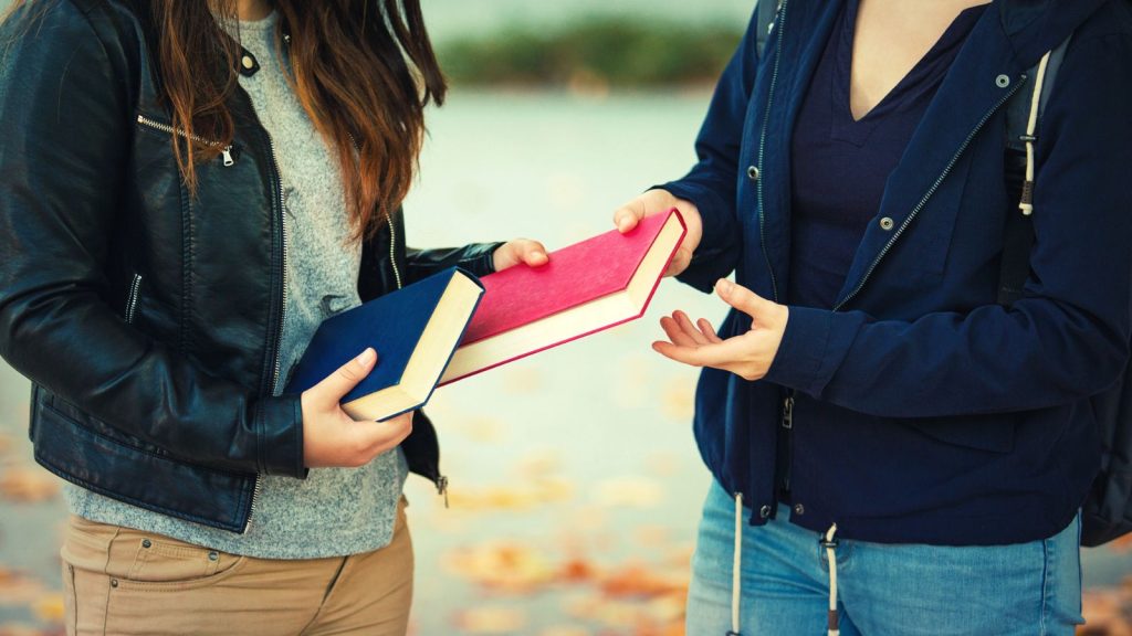 How to Finally Get Rid of Old Books When Decluttering 6 woman swapping books