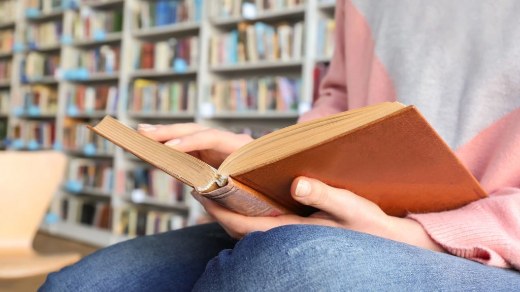 How to Finally Get Rid of Old Books When Decluttering 5 woman with book in hand