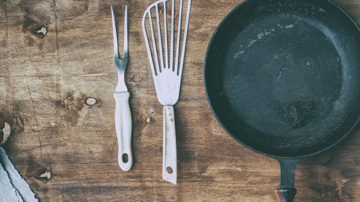 Never Do This to Your Cast Iron Skillet 8 empty-black-cast-iron-with-vintage-kitchen-items.jpg