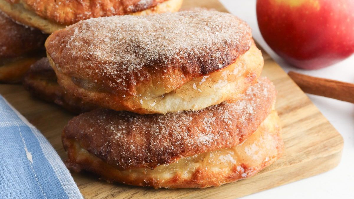 19 Sweet Treats That Start With a Can of Apple Pie Filling 1 Apple cinnamon donuts on a cutting board with cinnamon sticks.