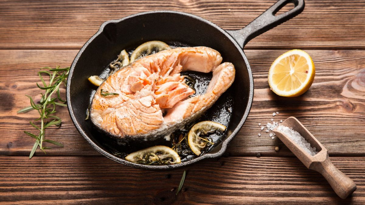 Fried salmon slice in a cast iron