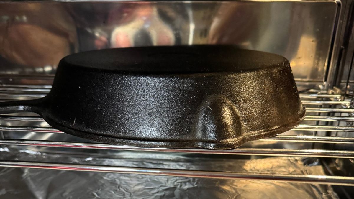 A black cast iron skillet sitting in an oven.