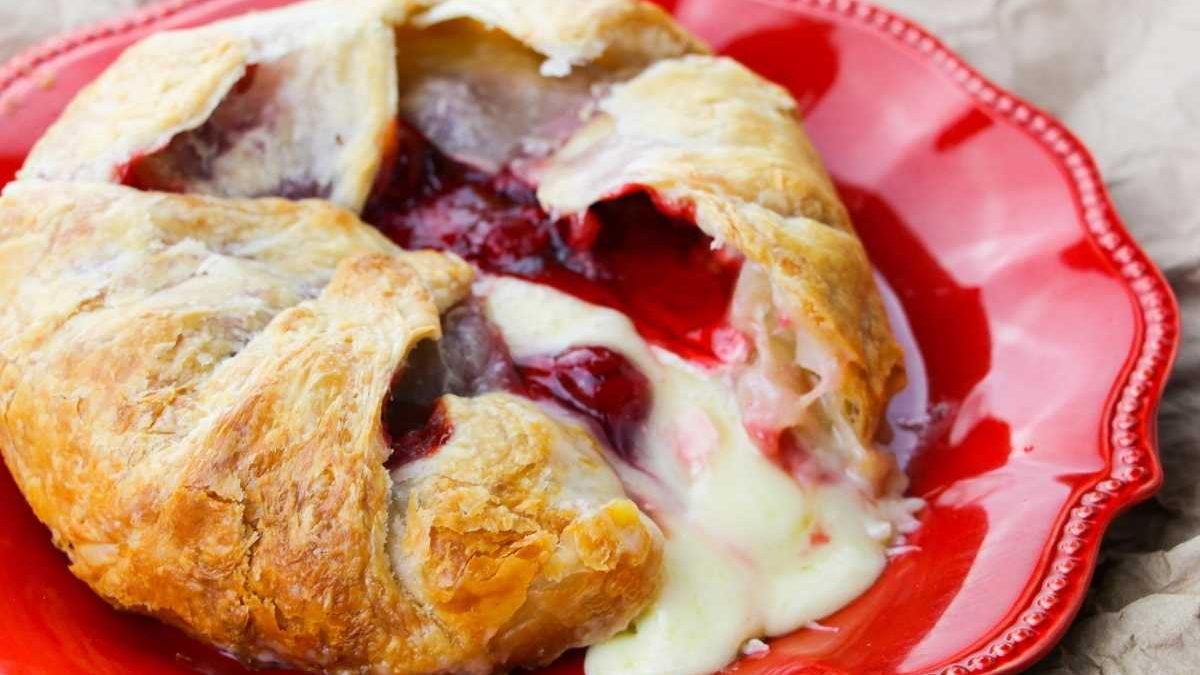 17 Easy Recipes That Start With a Can of Cherry Pie Filling 3 A red plate with a pastry filled with berries and cream.