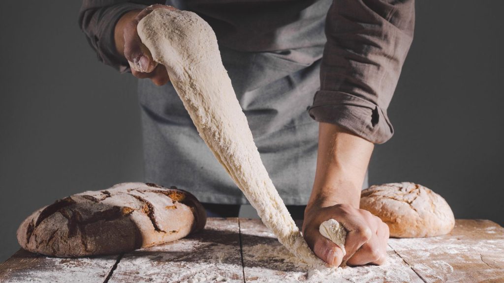 18 Creative Grandma-Era Hobbies That Relieve Stress and Boost Happiness 17 baker making bread from scratch
