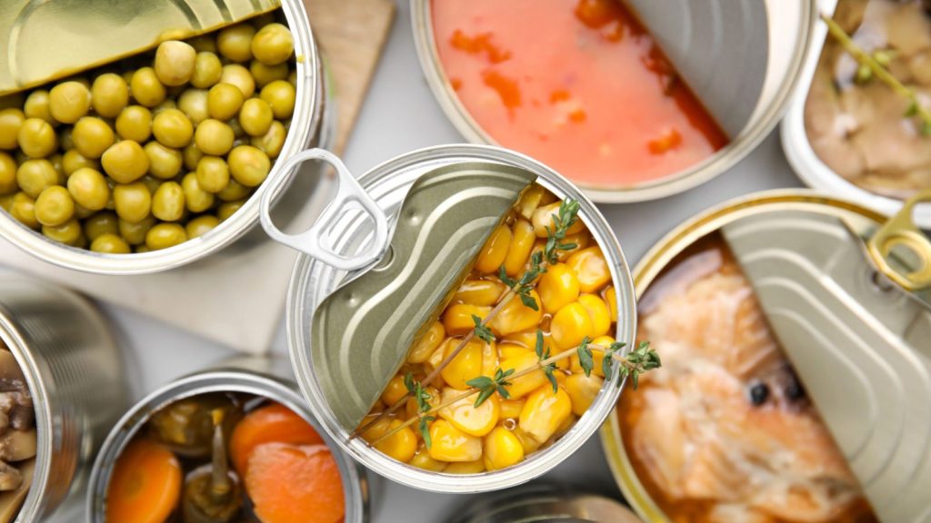 14 Preparedness Items to Stockpile Each Month for a Strong Emergency Stash 2 canned food open corn meat fish