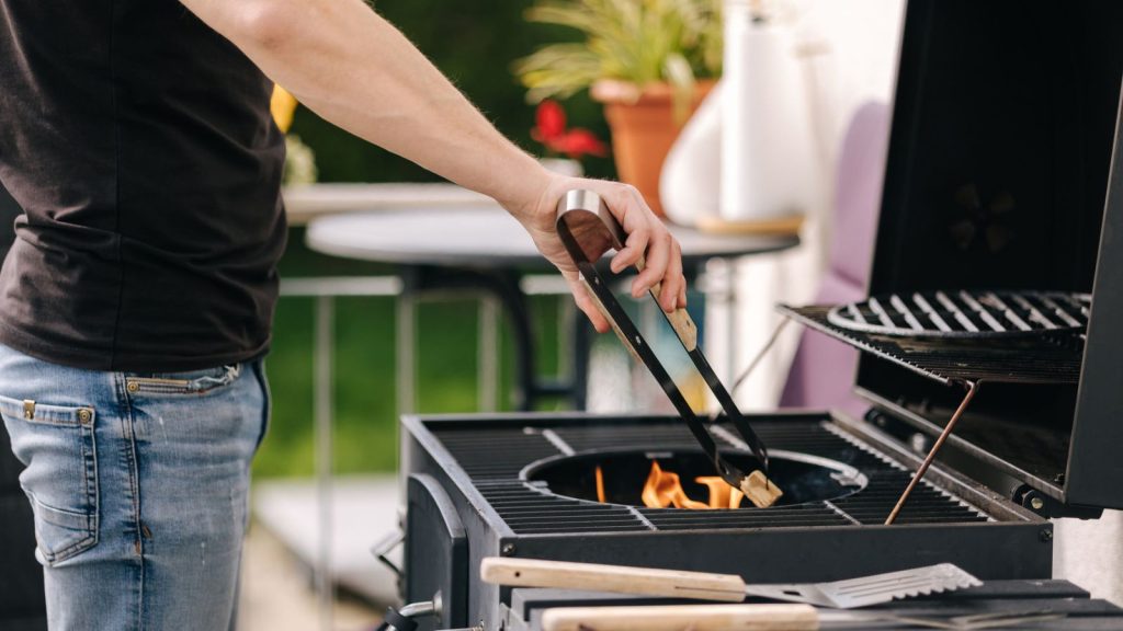 My Backyard Was Full of Mosquitoes—Here’s What Finally Worked 13 Man preparing grill