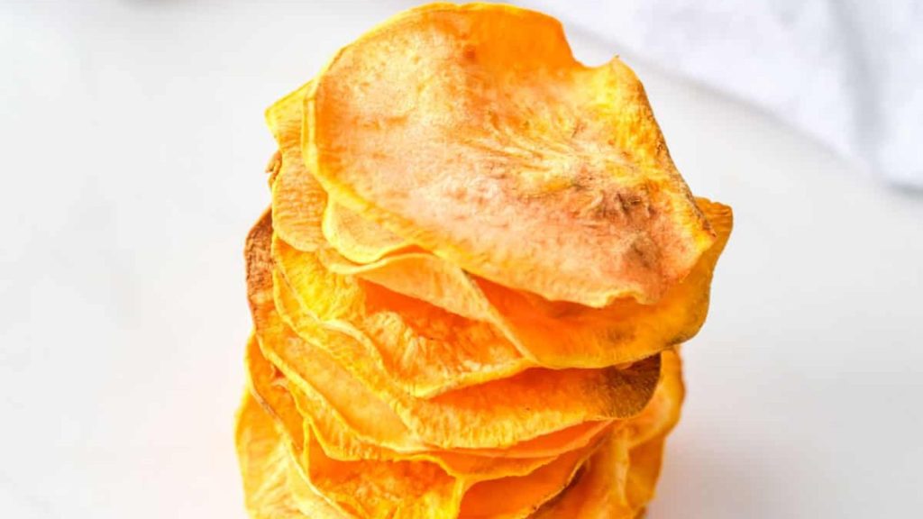 the completed air fryer sweet potato chips served in a white ceramic bowl
