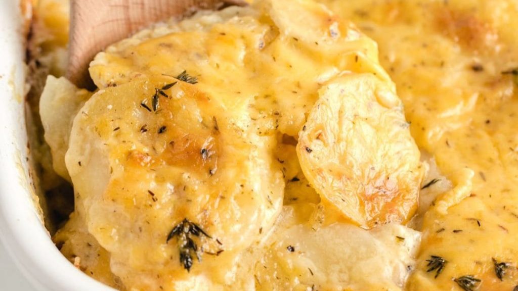 24 Potato Recipes You’ll Never Get Tired Of 12 Taking scalloped potatoes using wooden spoon