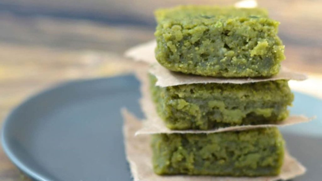 20 Matcha Recipes That’ll Make You Forget Chocolate Exists 17 A stack of 3 pieces of matcha mochi on a grey plate.