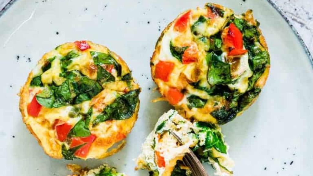 fork with piece of muffin tin egg bites on top of a plate