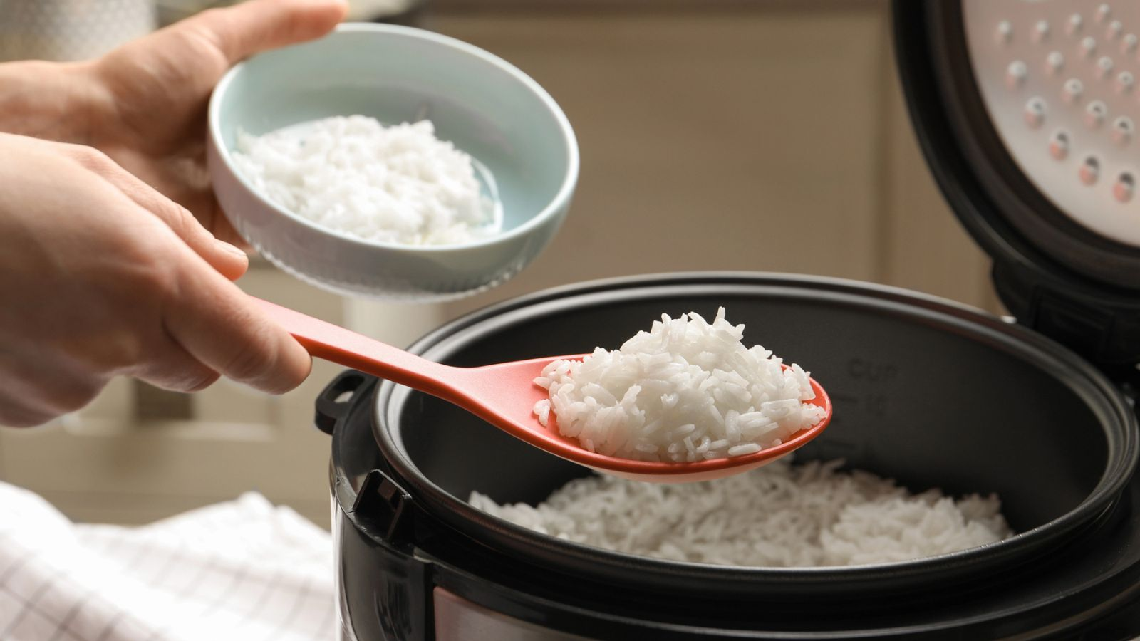 scooping rice from pot slow cooker