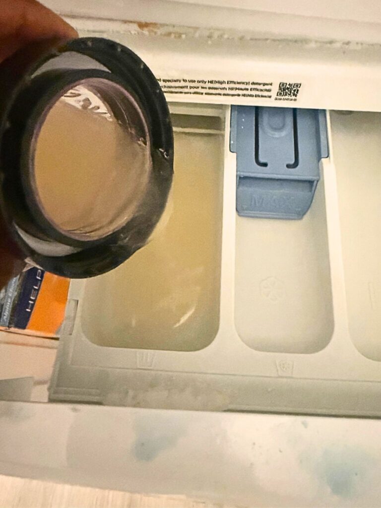 I Put This Men’s Laundry Detergent Up Against the Stinkiest Clothes in the Hamper—Here’s What Happened 2 clean guy detergent pouring